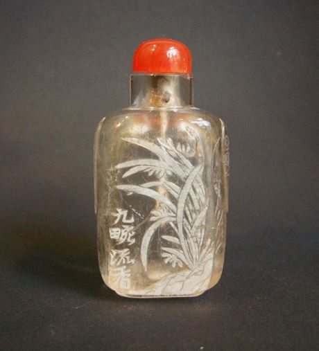 Snuff Bottles : rock crystal snuff bottle sculpted in the white with flowers reeds and a inscription   jiuwan liu xiang -   circa 1800/1850