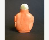 Snuff Bottles : rare coral snuff bottle sculpted with mask and ring handles  -

1800/1850