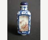 Snuff Bottles : snuff bottle porcelain quadrangular shape  decorated in underglaze blue with prunus flowers and for panels in copper red  with birds and insects in a landscape - Circa 19th century