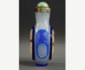 Snuff Bottles :   Blue overlay glass snuff bottle with a rare representation of a watch on each side in eglomized glass -
Circa 19th century