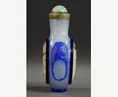 Snuff Bottles :   Blue overlay glass snuff bottle with a rare representation of a watch on each side in eglomized glass -
Circa 19th century