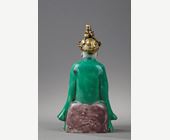 Works of Art : Figure seated in biscuit "Famille verte" with a golden bronze headdress -  19 th century
the bronze probably occidental
