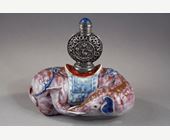 Works of Art : Elephant figure lying in porcelain carrying on its back a silver snuffbottle reticulated in the spirit of Mongolia most probably from the Beijing Imperials workshops and specially adapted for the back of the elephant-
Circa 1790/1820