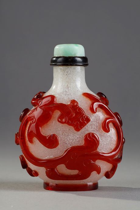 Snuff Bottles : Beautiful red glass snuffbottle overlay on bully background adorned on each side of a dragon shi China 1750/1820