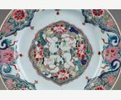 Polychrome : Porcelain plate Famille Rose with decoration of the two brothers Hehe in the center lying among the lotus. China circa 1730/40