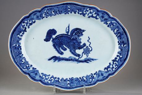 Blue White : Large dish with round edge in white blue porcelain bearing a decoration of a Fo dog or Buddhist lion playing with one of the eight precious objects the sapphire symbolizing wealth 
 - China Qianlong period 1736/1795