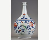 Japanese : Bottle pharmacy with double ring collar. porcelain decorated in blue under cover and polychrome enamels of birds among the branches of pomegranate peony and camellia Japan  Arita  kilns late 17th century