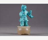 Works of Art : Finely carved turquoise statuettes - China Qing period circa 1900
1)Depicting a young woman pressing fruit on a tray on a barrel-shaped stool 
2) representing a child on a soapstone base 