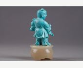 Works of Art : Finely carved turquoise statuettes - China Qing period circa 1900
1)Depicting a young woman pressing fruit on a tray on a barrel-shaped stool 
2) representing a child on a soapstone base 