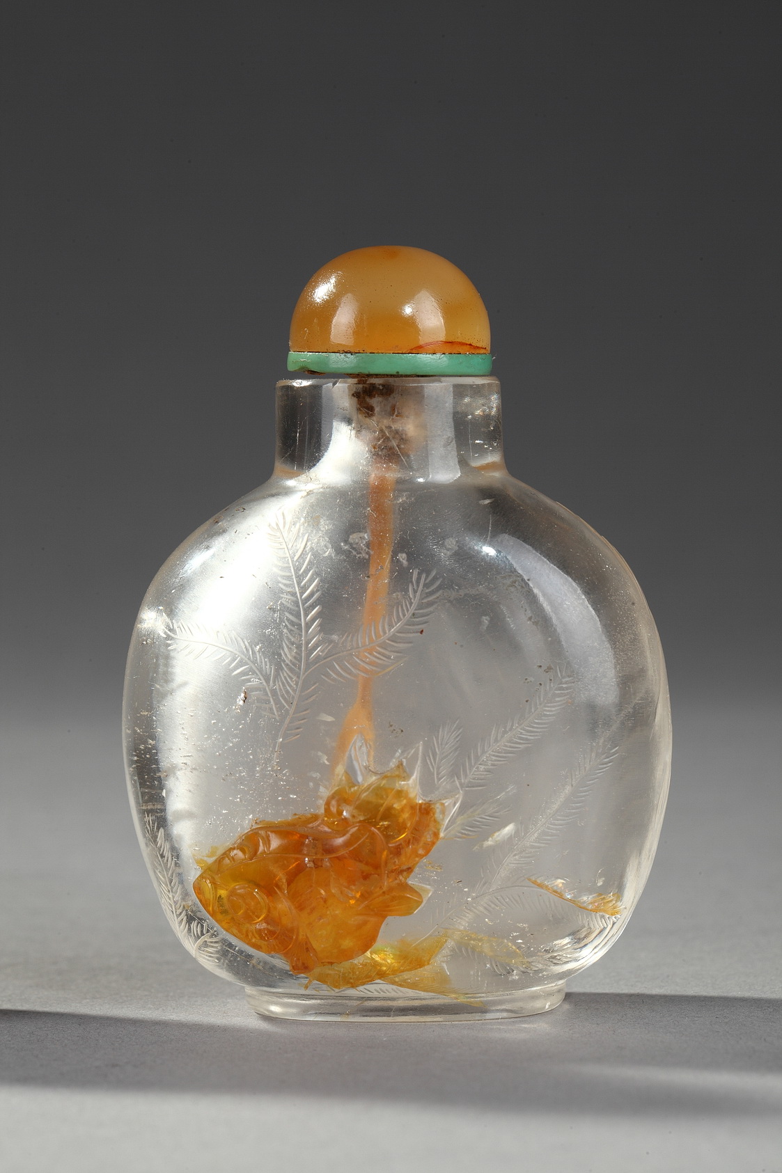 Works of Art : 
THE ROCK CRYSTAL: This hard stone has always been highly sought after for crafting art objects. In the West, from Renaissance to the 18th century, it was his golden age. Louis XIV adored this stone and you can admire some pieces of his collection at the Louvre a Paris.  IN CHINA, its apogee was during the Manchous dynasty of the Qing (1644-1911). Some call this translucent stone "Water Jade" - Under the Qing, it experienced a golden age with the production of refined imperial objects in the workshops of the Forbidden City.





Superbe rock Crystal snuff bottle sculpted in the yellow vein  with fish and engraved  aquatic plants and other side with pavillon
Rustic Crystal master   1750/1820
