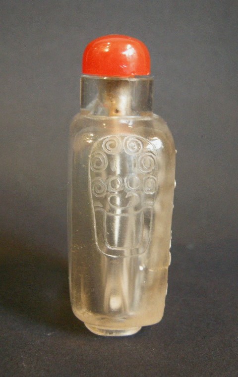 Snuff Bottles : rock crystal snuff bottle sculpted in the white with flowers reeds and a inscription   jiuwan liu xiang -   circa 1800/1850