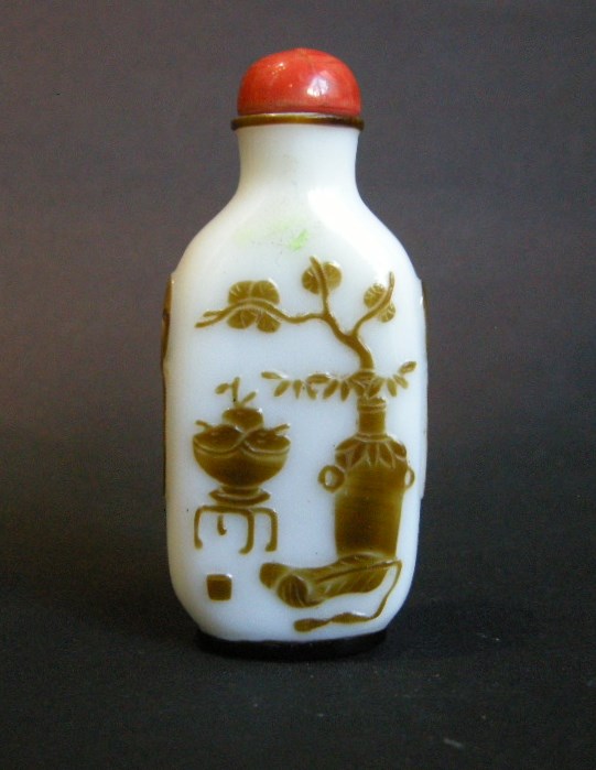Snuff Bottles : snuff bottle overlay  glass Brown on white ground  sculpted with a mobilar decor 
Yangzhou school 1800/1870