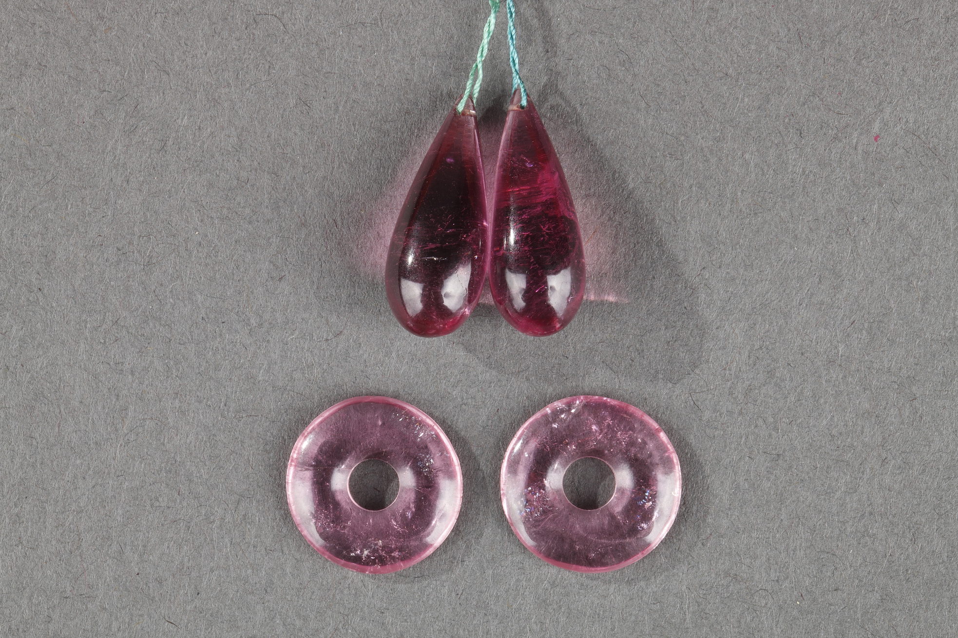 Works of Art : Four Chinese tourmaline pendant ,two drop-shapedand two ring-shaped .Circa 1900 -