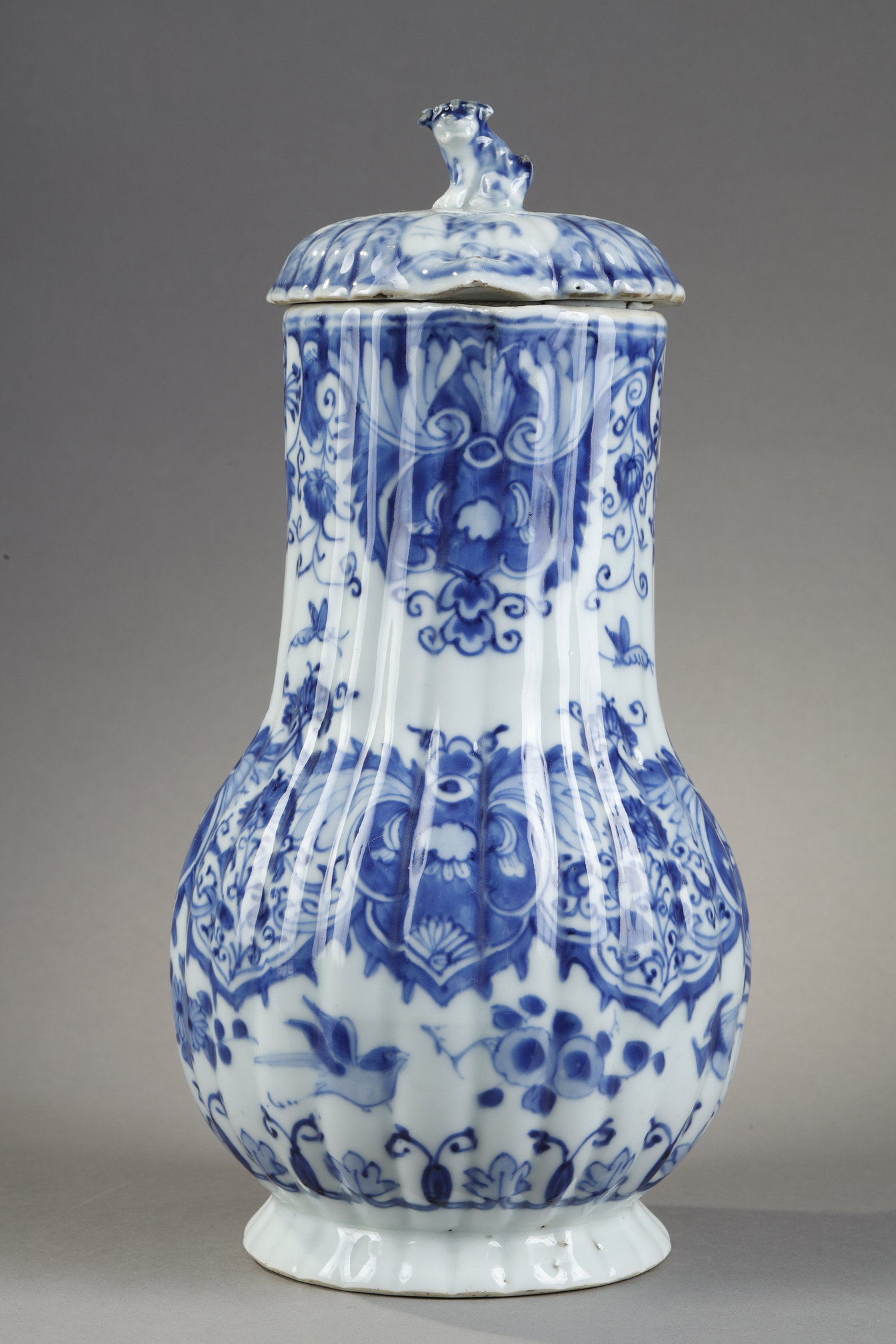 Blue White :  blue and white porcelain jug and cover decorated with butterfly birds flowers and lambrequins in the taste of Delft . On the cover the dog shape - China epoque Kangxi 1662/1722 around 1700 1720