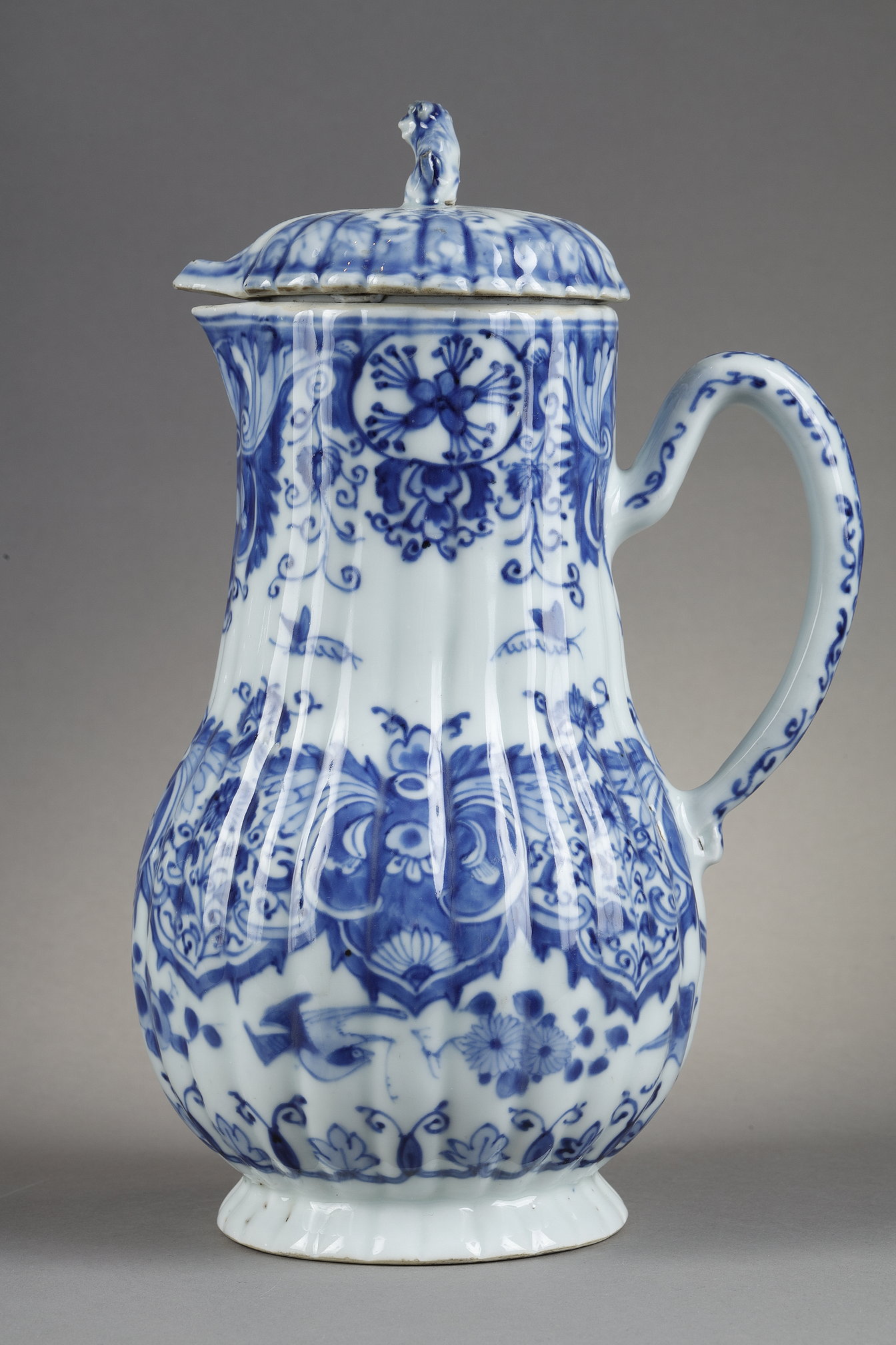 Blue White :  blue and white porcelain jug and cover decorated with butterfly birds flowers and lambrequins in the taste of Delft . On the cover the dog shape - China epoque Kangxi 1662/1722 around 1700 1720