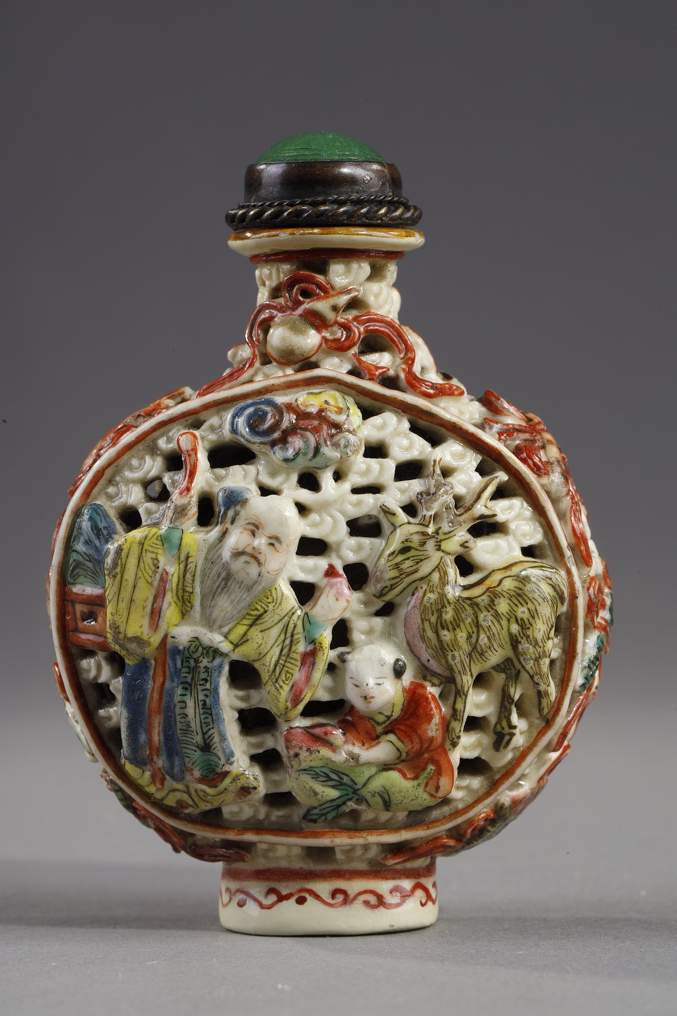 Snuff Bottles : Snuff bottle porcelain molded and reticulated with decor Shou Lao deer and children on a face  and other face with two figures and children  and Buddhist emblems on the sides - Imperial Jingdezhen kilns  Jiaqing mark and period 1796/1820