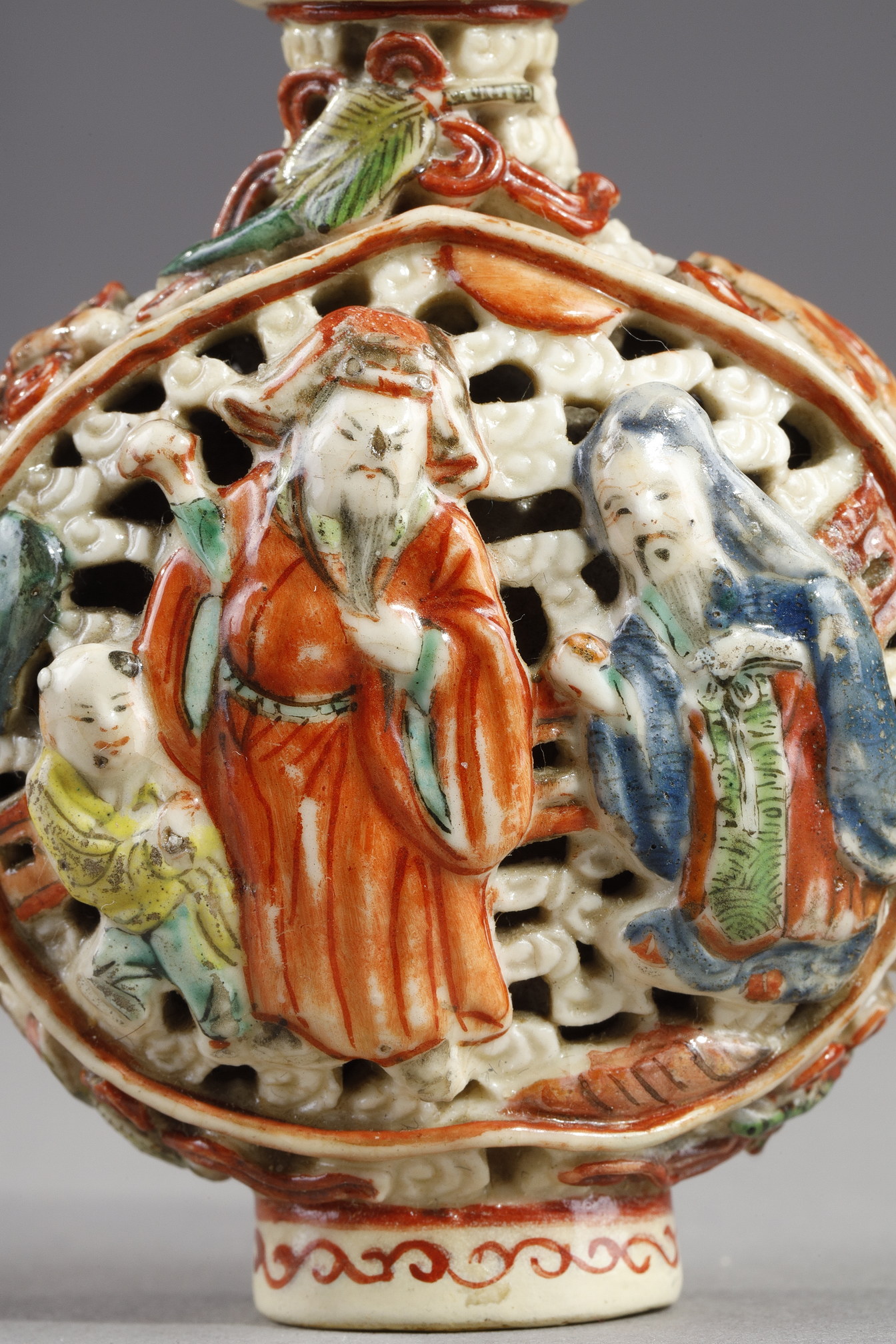 Snuff Bottles : Snuff bottle porcelain molded and reticulated with decor Shou Lao deer and children on a face  and other face with two figures and children  and Buddhist emblems on the sides - Imperial Jingdezhen kilns  Jiaqing mark and period 1796/1820