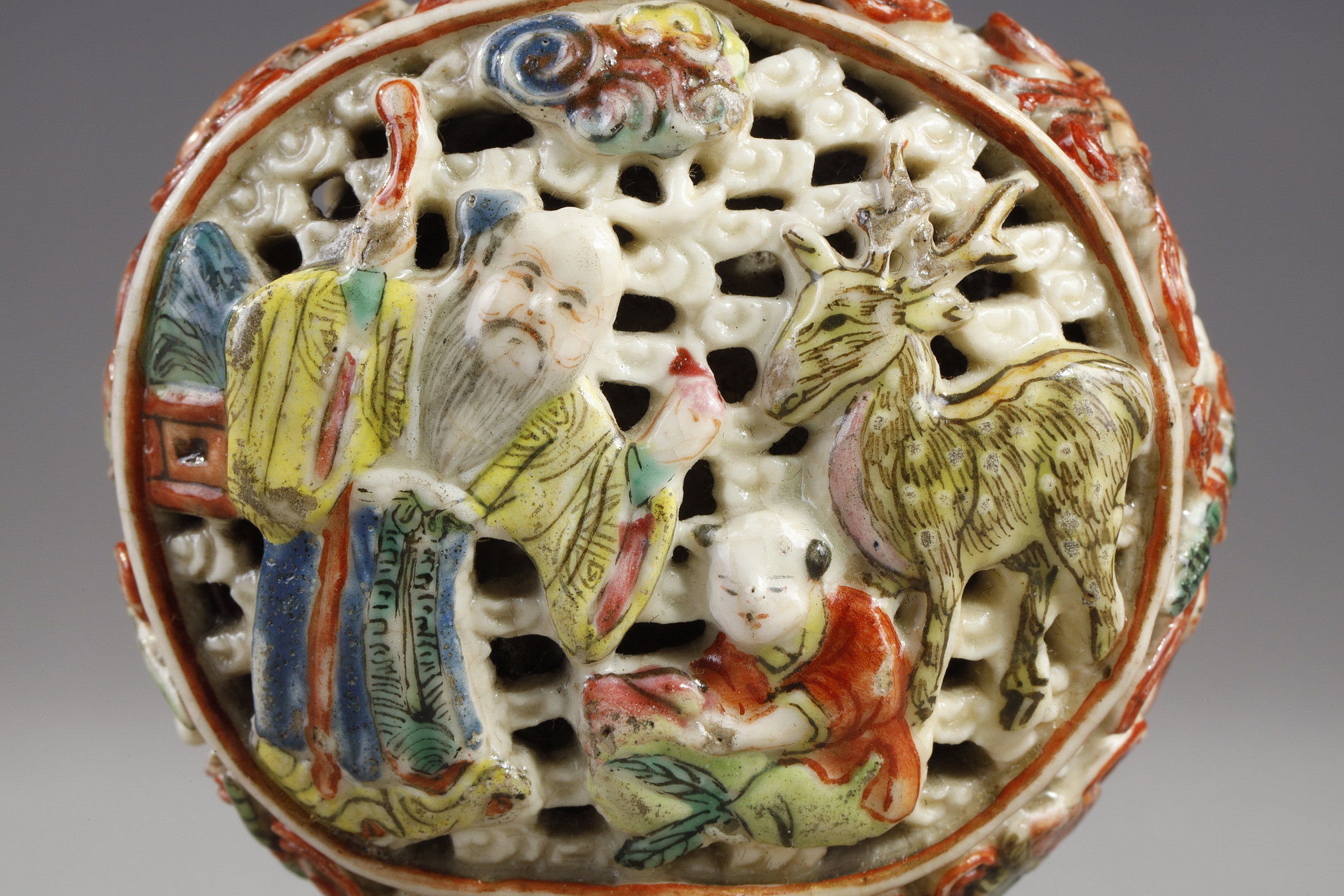Snuff Bottles : Snuff bottle porcelain molded and reticulated with decor Shou Lao deer and children on a face  and other face with two figures and children  and Buddhist emblems on the sides - Imperial Jingdezhen kilns  Jiaqing mark and period 1796/1820