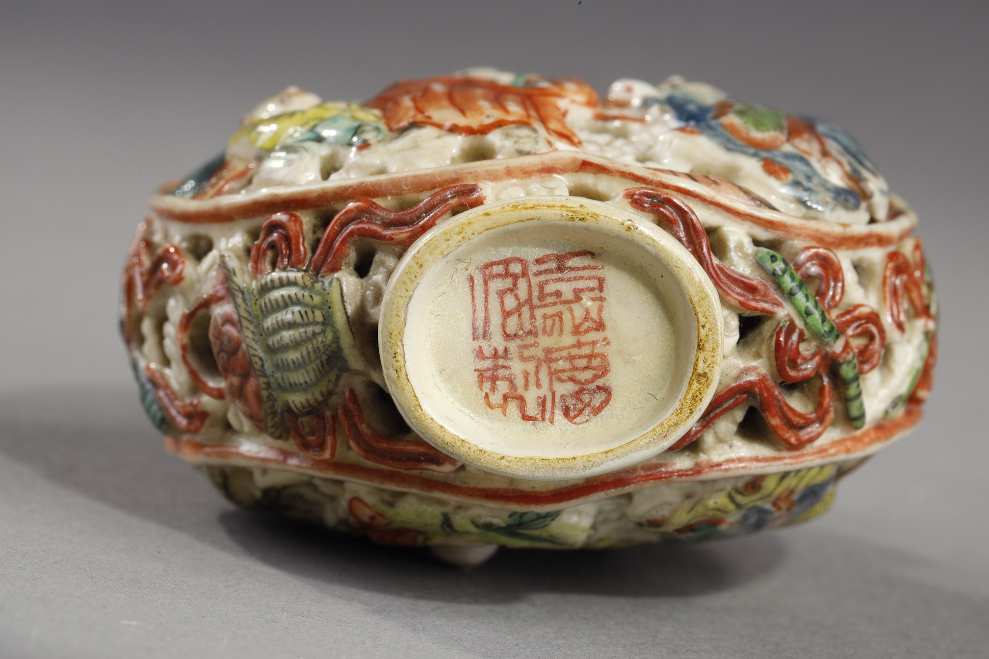 Snuff Bottles : Snuff bottle porcelain molded and reticulated with decor Shou Lao deer and children on a face  and other face with two figures and children  and Buddhist emblems on the sides - Imperial Jingdezhen kilns  Jiaqing mark and period 1796/1820