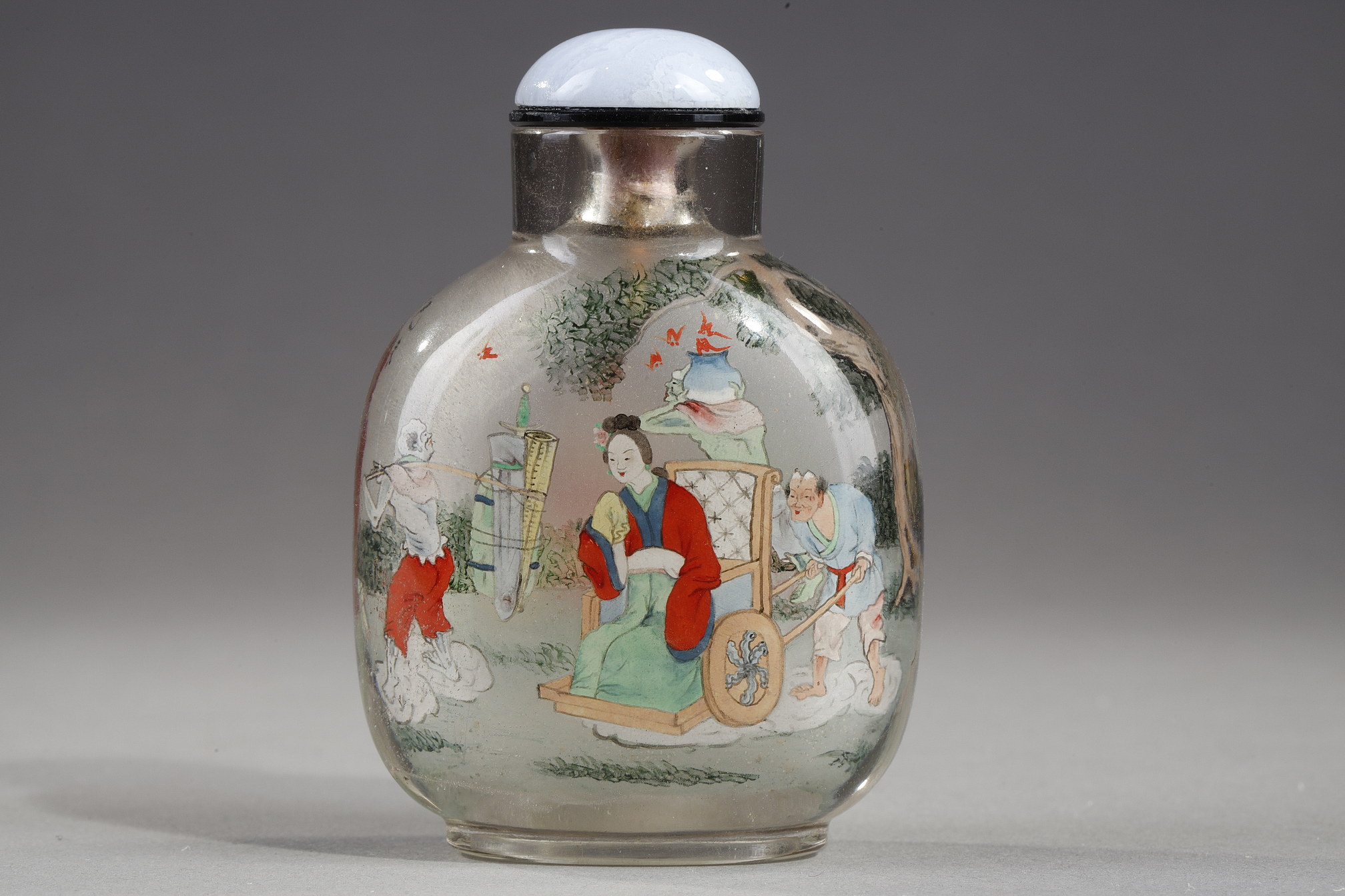 Snuff Bottles : Rock crystal snuff bottle painted in its interior of Zhong Kui surrounded by demons on one side and on the other the sister of Zhong Kui on a char signed by Ye Zhongsan and dated 1919