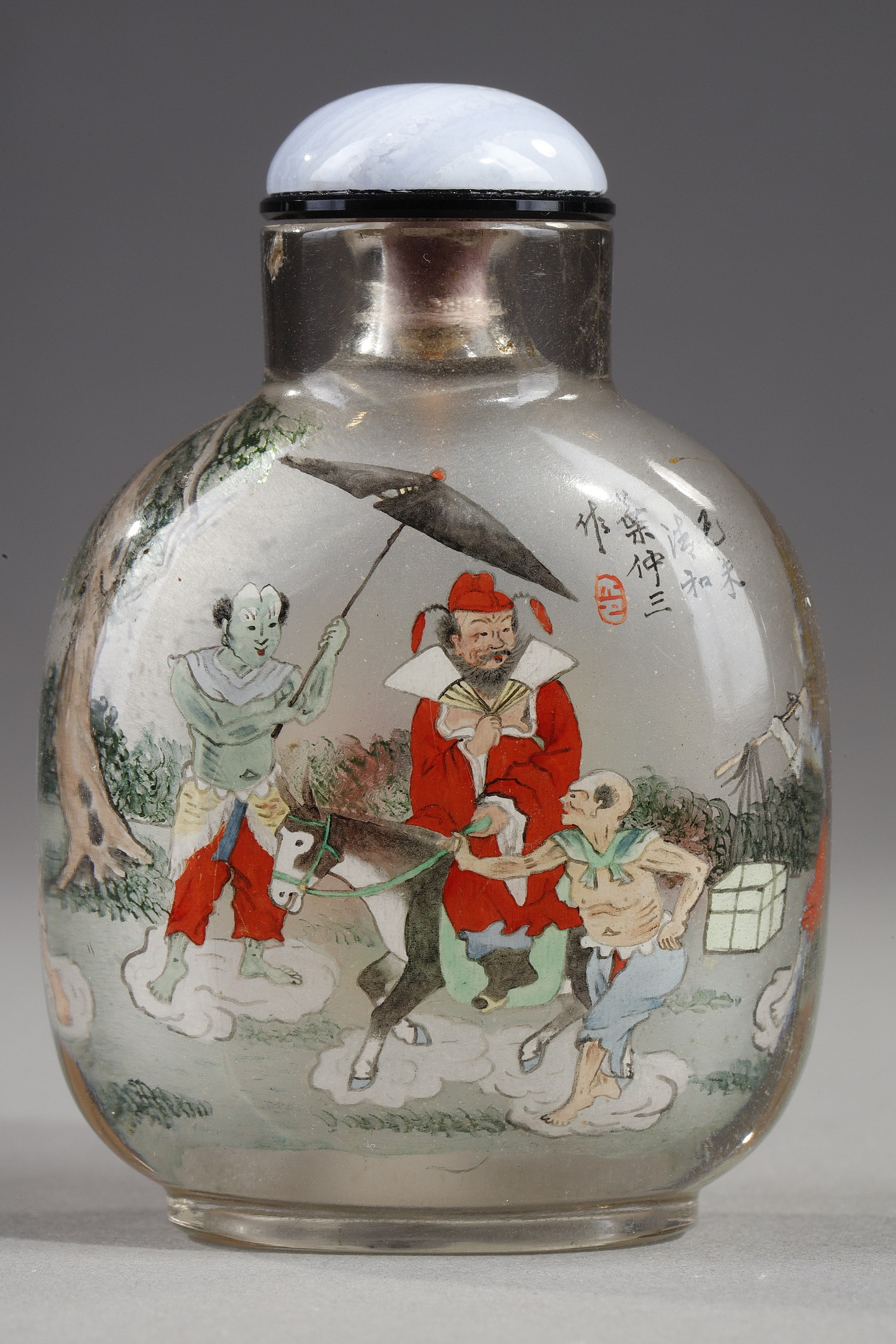 Snuff Bottles : Rock crystal snuff bottle painted in its interior of Zhong Kui surrounded by demons on one side and on the other the sister of Zhong Kui on a char signed by Ye Zhongsan and dated 1919
