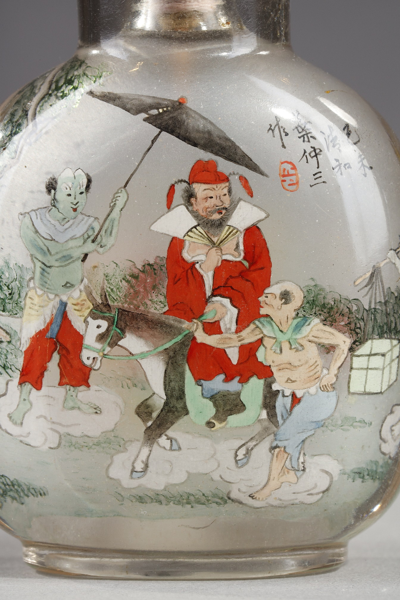 Snuff Bottles : Rock crystal snuff bottle painted in its interior of Zhong Kui surrounded by demons on one side and on the other the sister of Zhong Kui on a char signed by Ye Zhongsan and dated 1919
