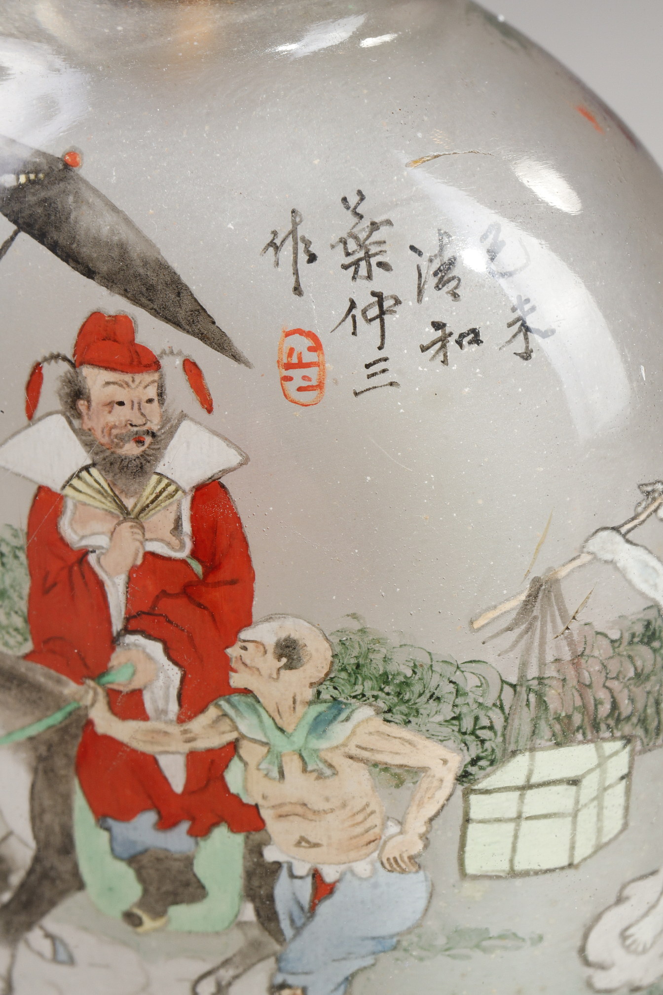 Snuff Bottles : Rock crystal snuff bottle painted in its interior of Zhong Kui surrounded by demons on one side and on the other the sister of Zhong Kui on a char signed by Ye Zhongsan and dated 1919