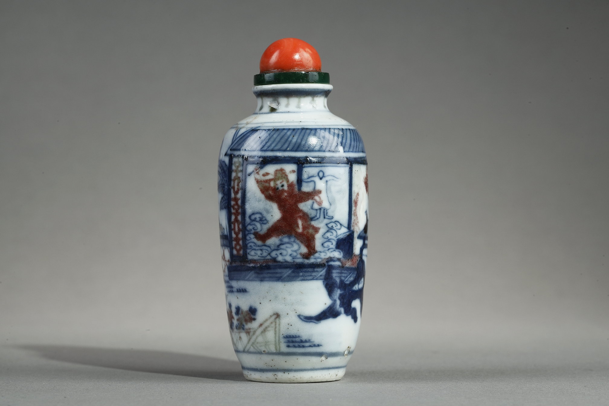Snuff Bottles : Enameled snuff bottle painted in underglaze blue  and red copper with a decor of an interior scene with
the ghostly "Gui" - Apocryphal mark Qianlong - 19th century China
