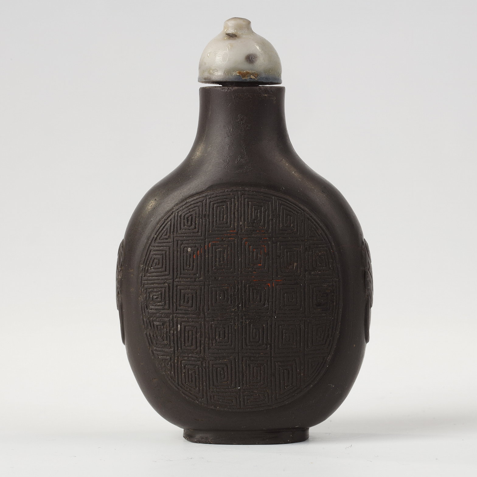 Snuff Bottles : snuff bottle in duanstone slightly decorated in relief masks with shoulders -China 1780/1850
