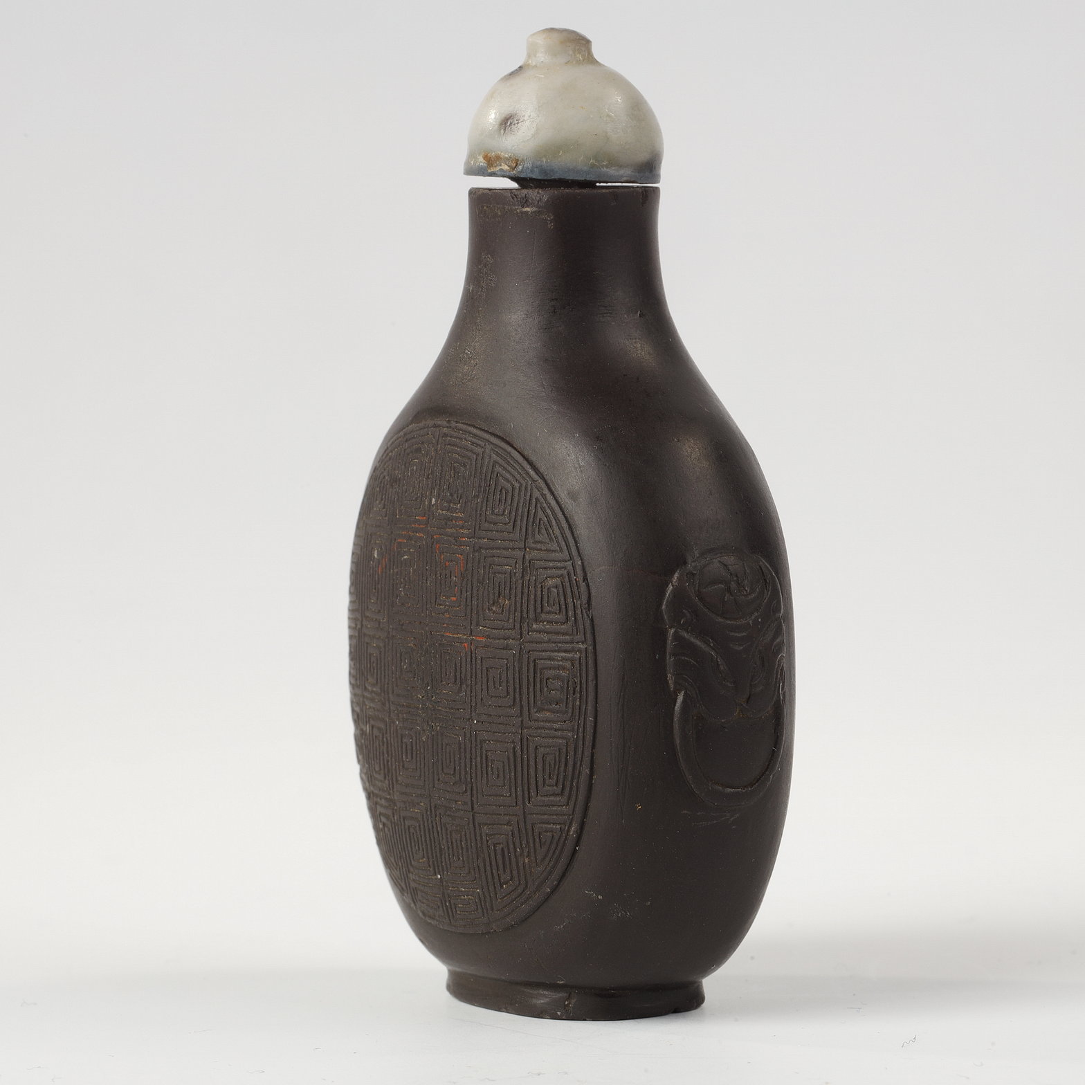 Snuff Bottles : snuff bottle in duanstone slightly decorated in relief masks with shoulders -China 1780/1850