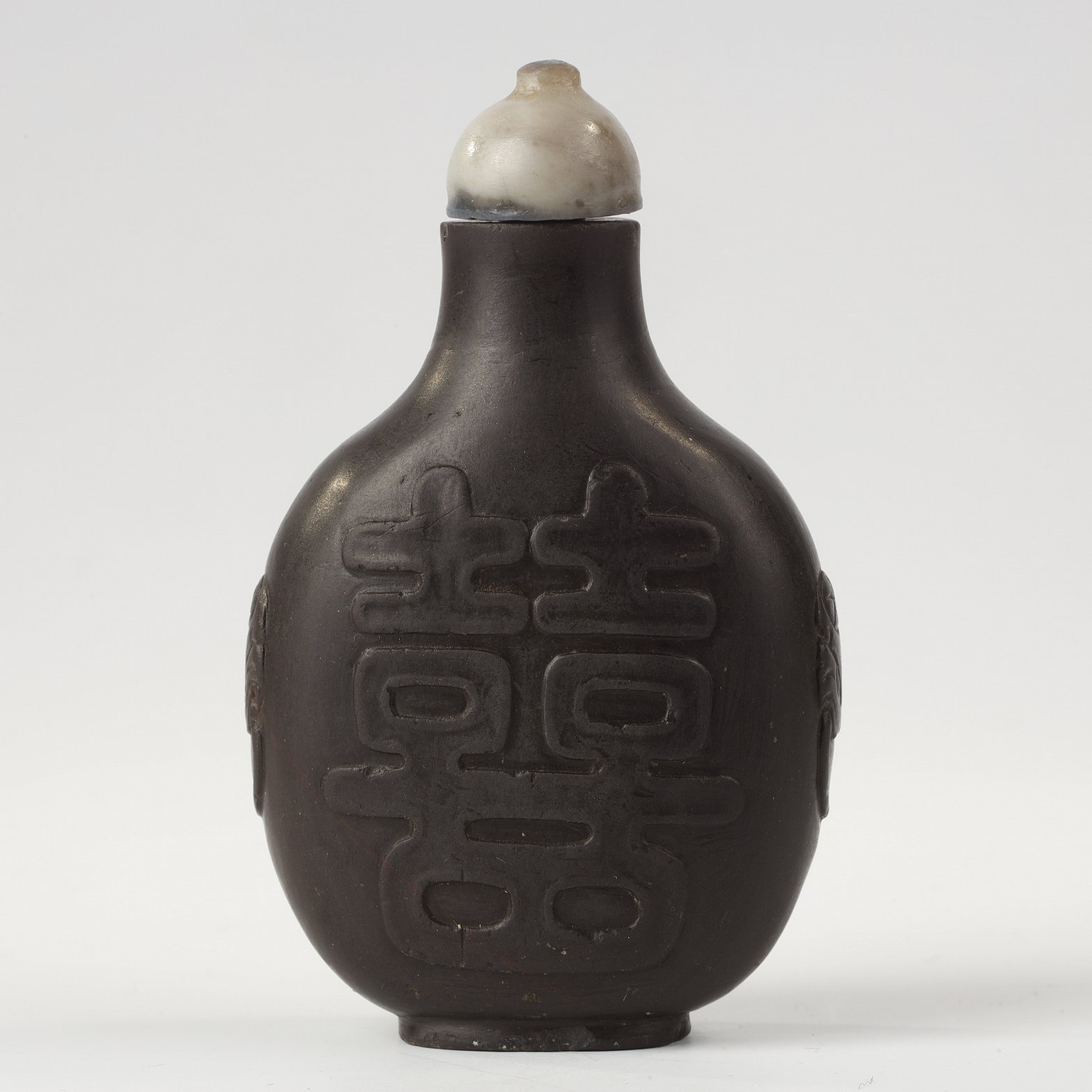 Snuff Bottles : snuff bottle in duanstone slightly decorated in relief masks with shoulders -China 1780/1850