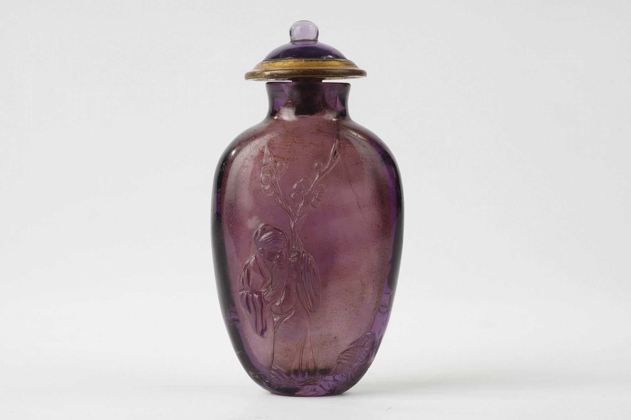 Snuff Bottles : Glass snuff bottle perfectly imitating the amethyst decorated with a sage holding a prunus branch next to a duck and on the other side of a prunus overflown by a bird. 1780/1820