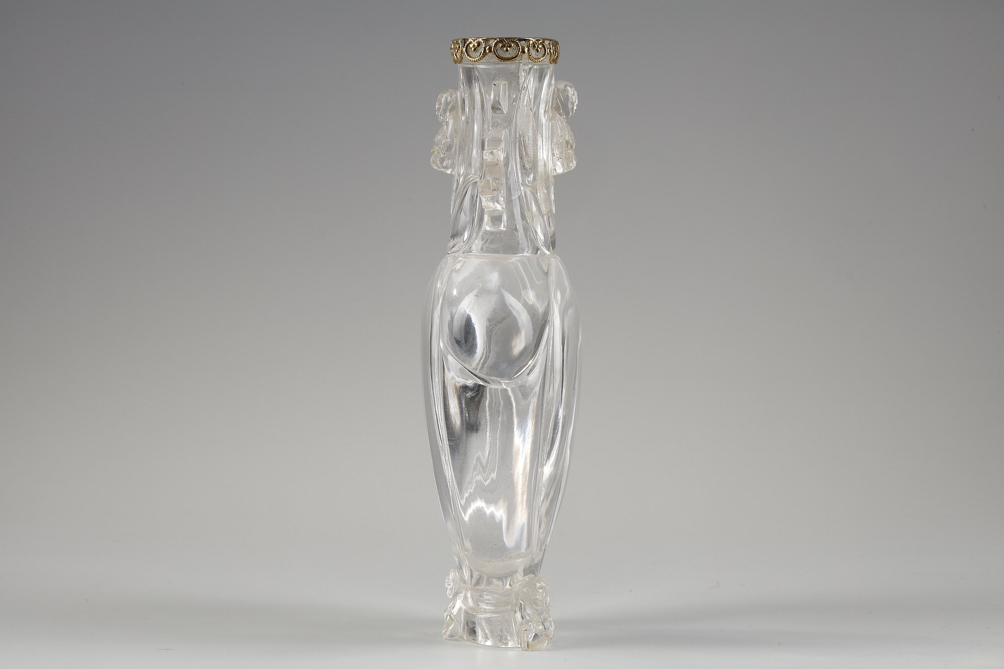 Works of Art : Carved rock crystal vase, the polylobed body, budai leaning against the foot and collar, the handles in the shape of stylized dragons. China around 1900 
The collar rimmed with gold  in the shape of a lingzhi       H 13.6cm