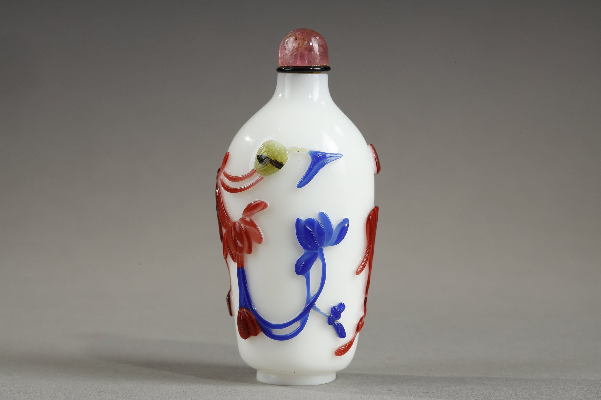 Snuff Bottles : Cylindrical shaped snuff bottle in three colors on opaque white background decorated with flowers and bamboo stems China 1780/1850