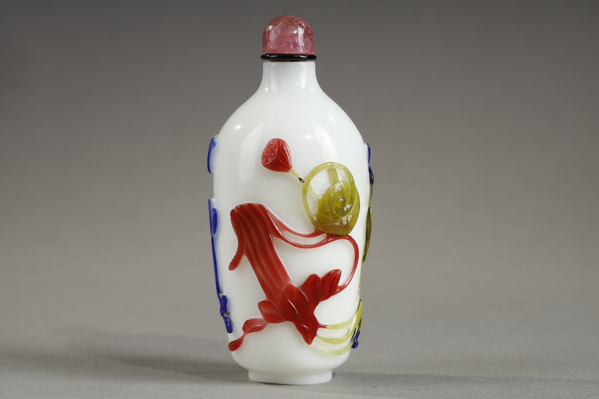 Snuff Bottles : Cylindrical shaped snuff bottle in three colors on opaque white background decorated with flowers and bamboo stems China 1780/1850