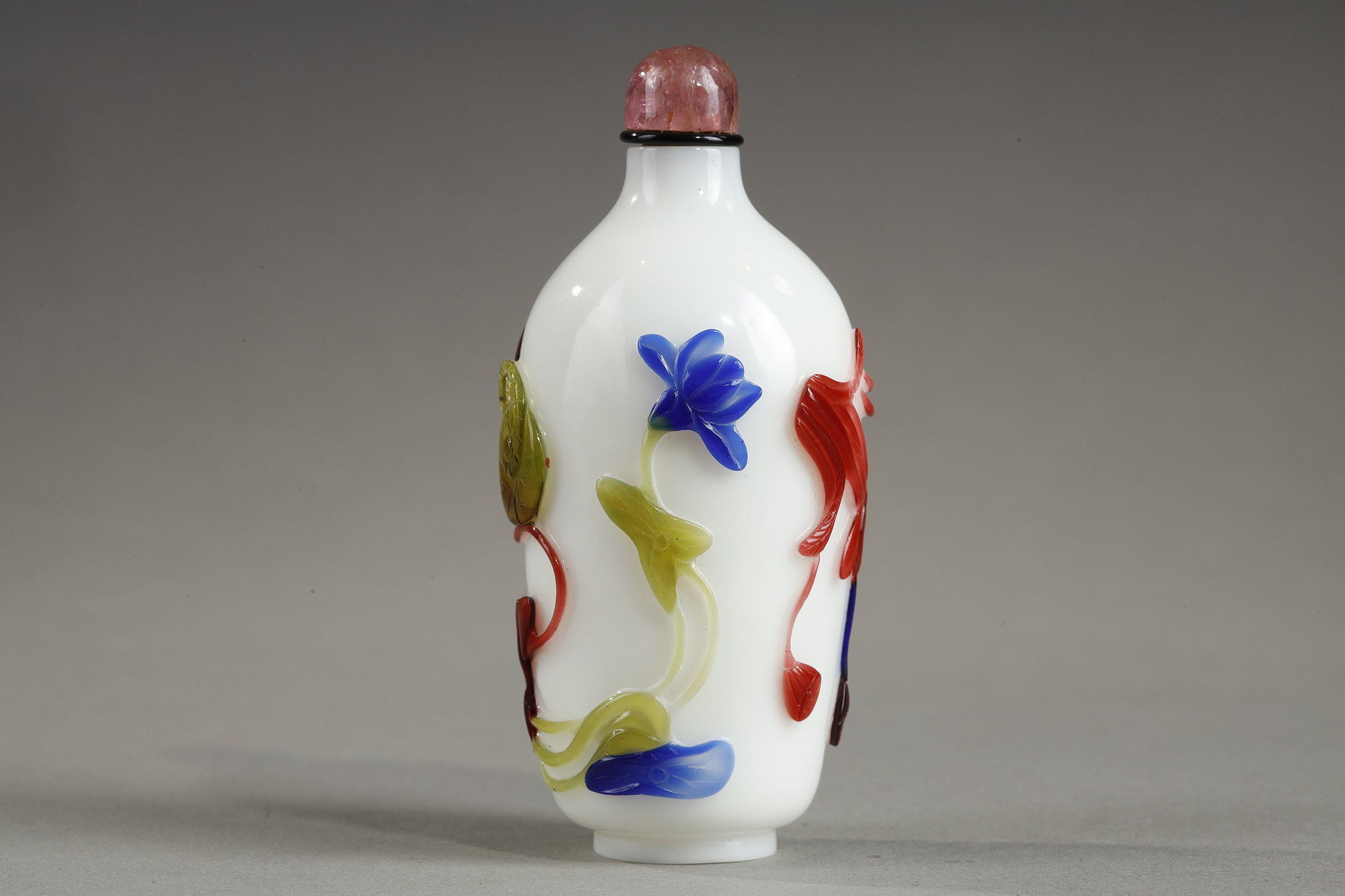 Snuff Bottles : Cylindrical shaped snuff bottle in three colors on opaque white background decorated with flowers and bamboo stems China 1780/1850