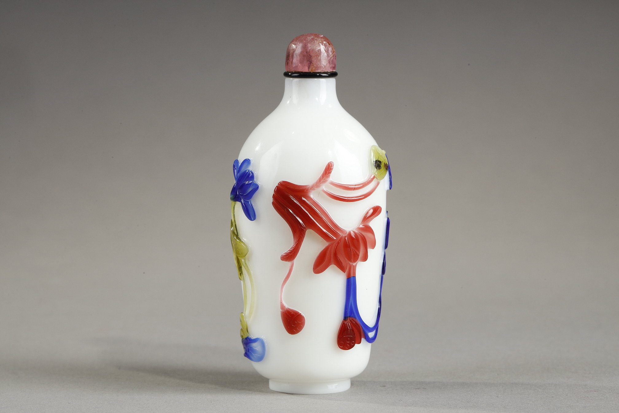 Snuff Bottles : Cylindrical shaped snuff bottle in three colors on opaque white background decorated with flowers and bamboo stems China 1780/1850