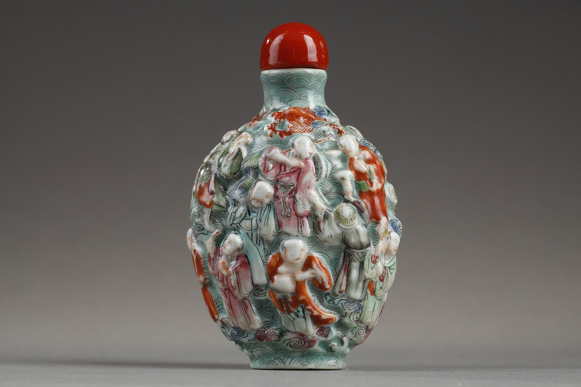 Snuff Bottles : Chinese polychrome moulded porcelain snuff bottle decorated witrh the eighteen Lohans -
Jiaqing period   1796/1820