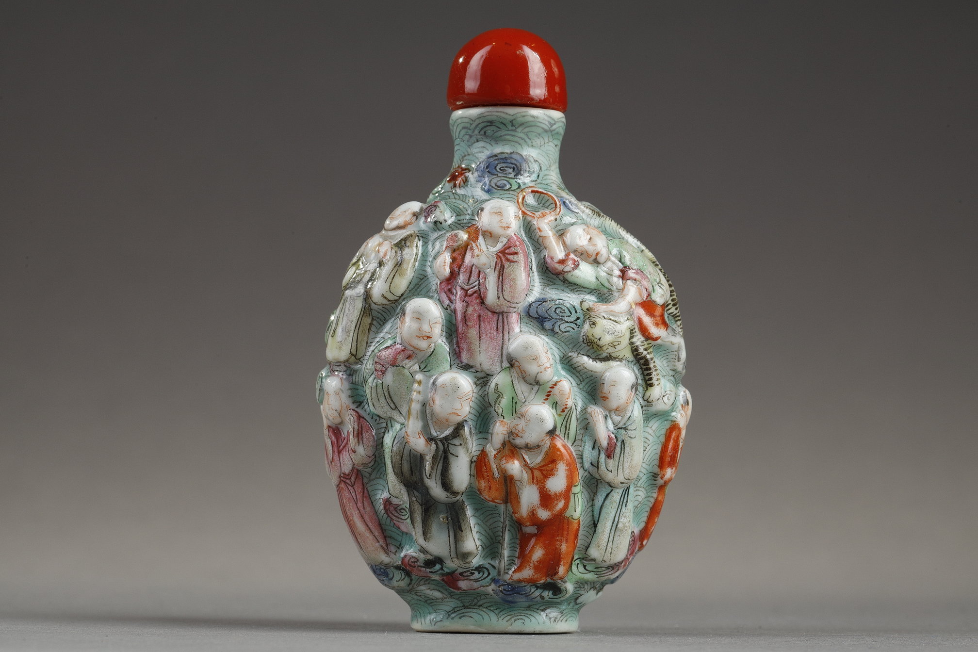 Snuff Bottles : Chinese polychrome moulded porcelain snuff bottle decorated witrh the eighteen Lohans -
Jiaqing period   1796/1820