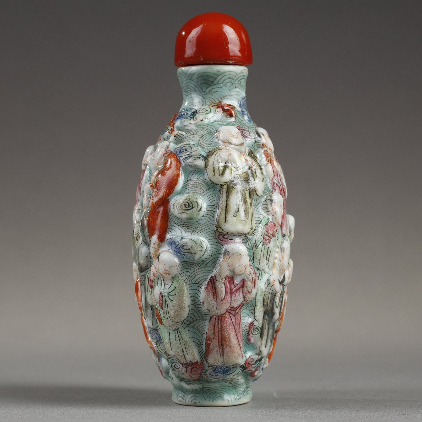 Snuff Bottles : Chinese polychrome moulded porcelain snuff bottle decorated witrh the eighteen Lohans -
Jiaqing period   1796/1820