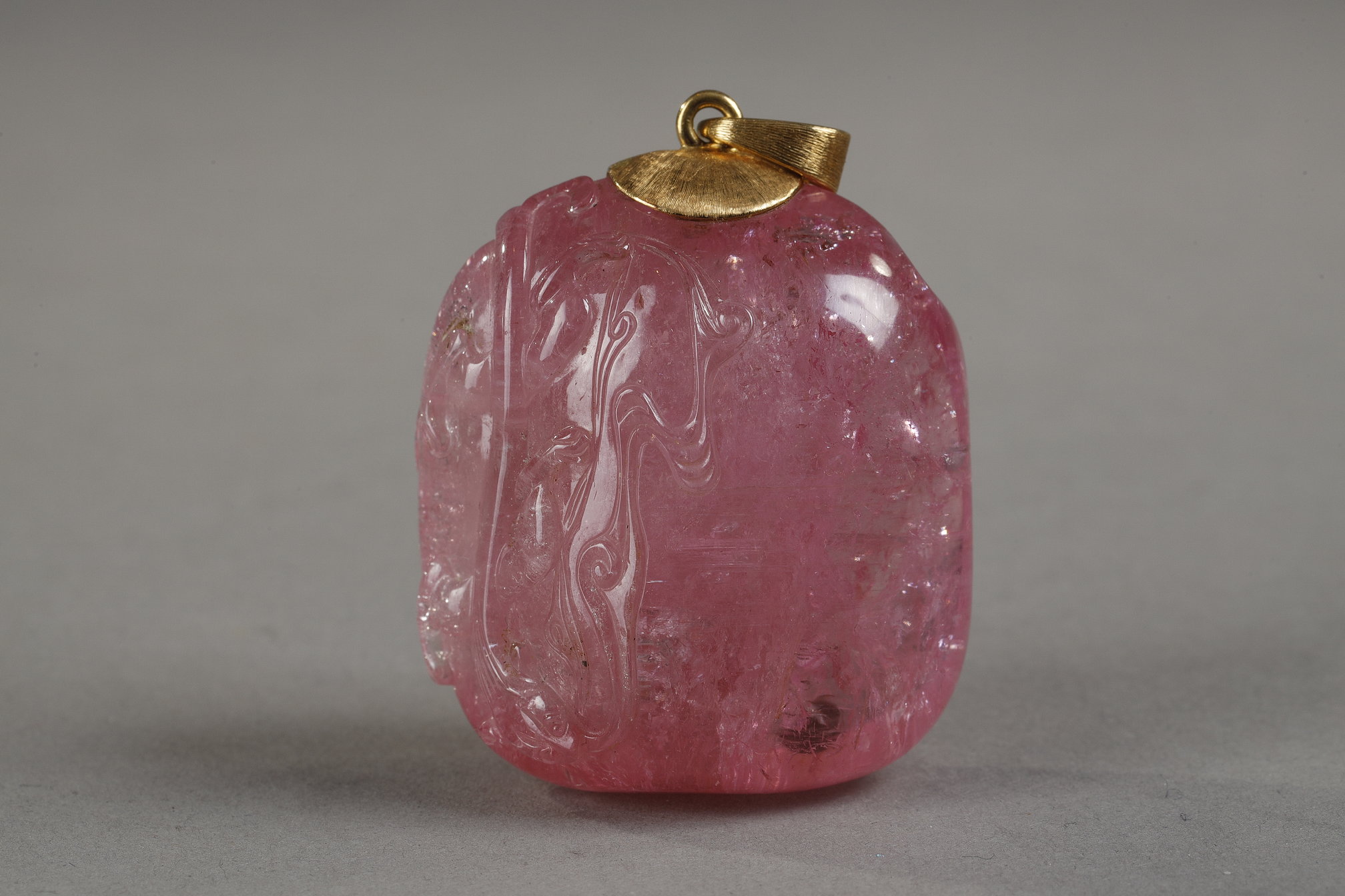 Works of Art : Tourmaline pendant finely sculpted in relief of a qilong holding a lingzhi branch - Chinese 19th century