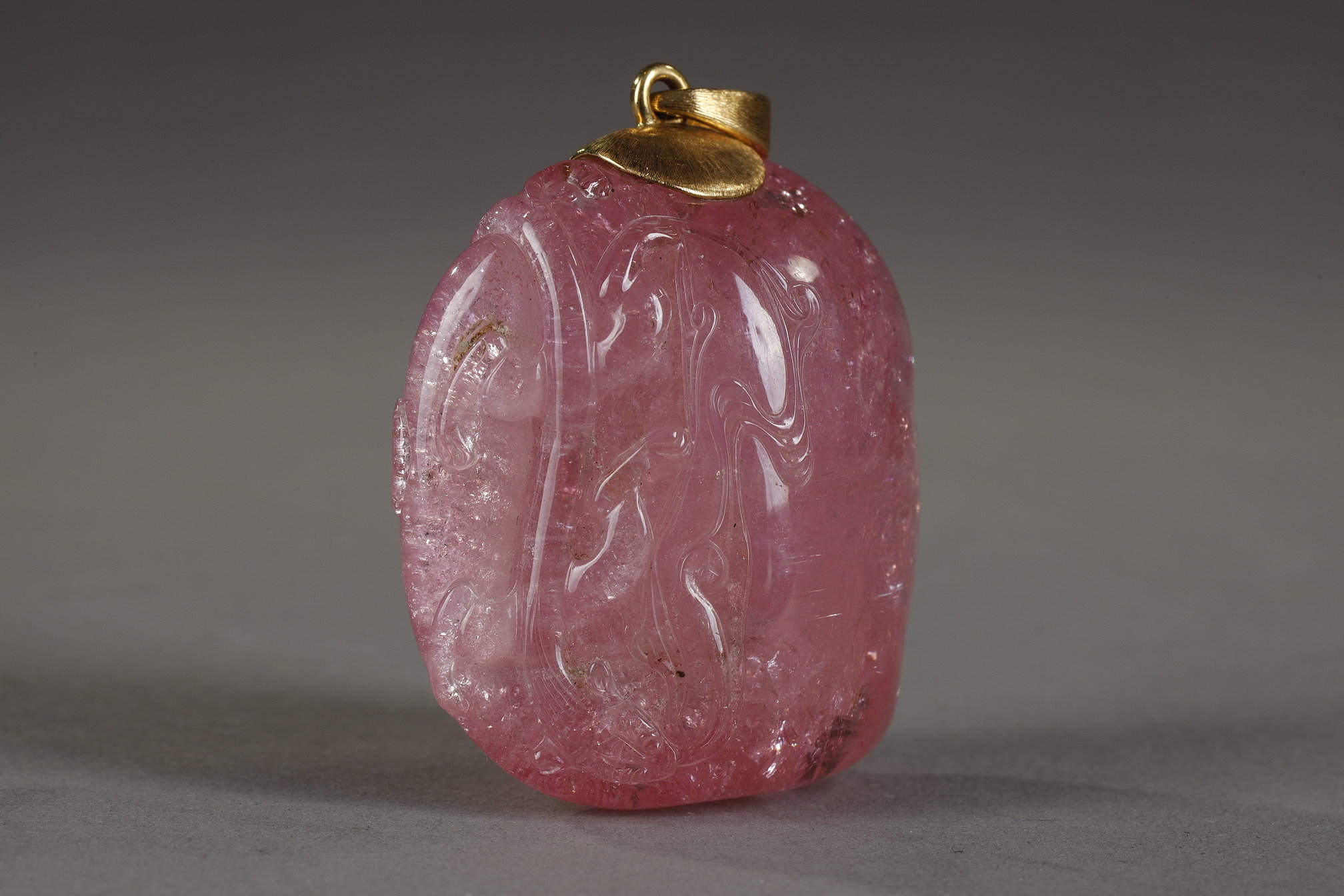 Works of Art : Tourmaline pendant finely sculpted in relief of a qilong holding a lingzhi branch - Chinese 19th century