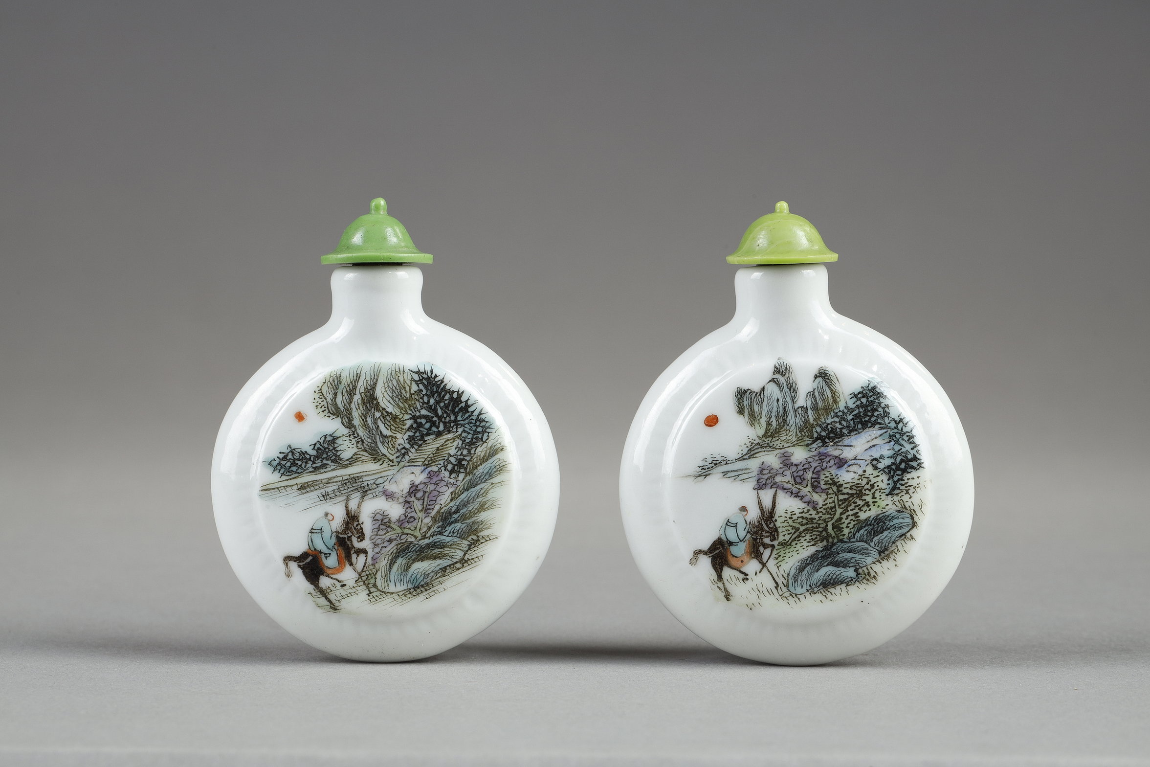 Snuff Bottles : two porcelain snuff bottles in the form of watches painted in polychrome landscapes in the style of traditional Chinese painting. China 19th century