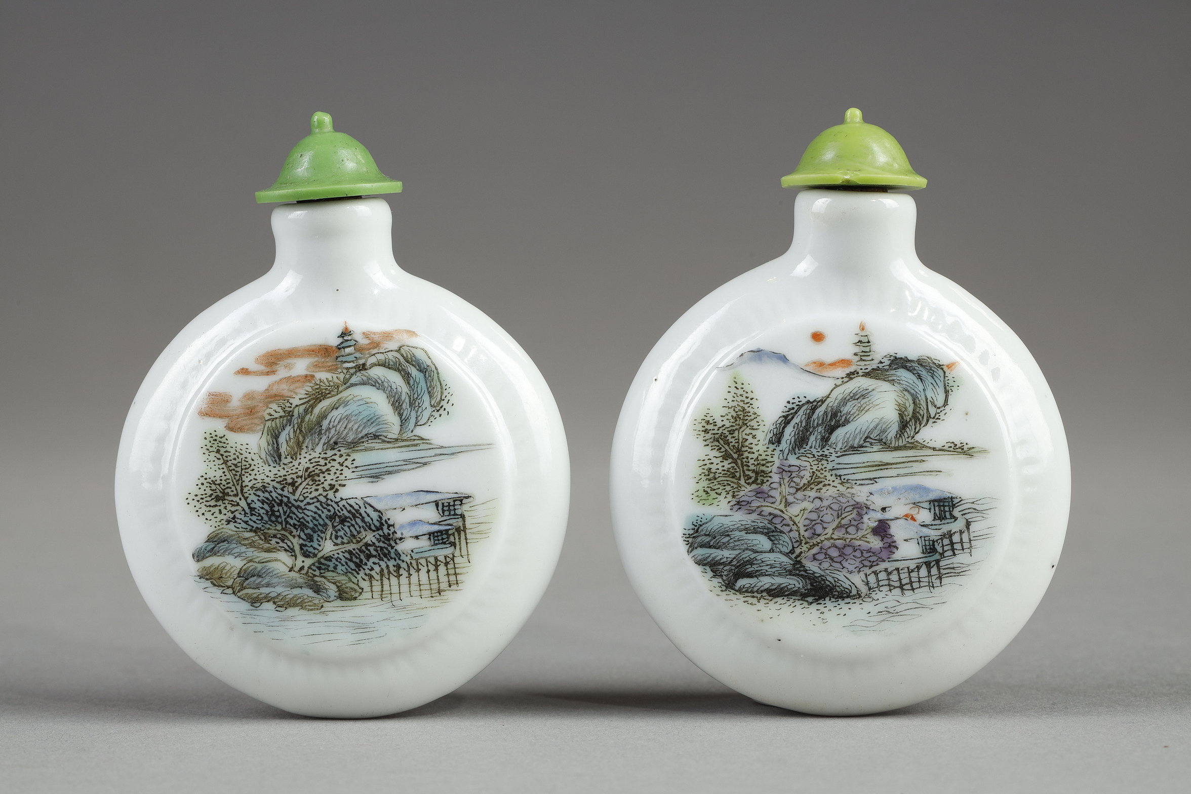 Snuff Bottles : two porcelain snuff bottles in the form of watches painted in polychrome landscapes in the style of traditional Chinese painting. China 19th century