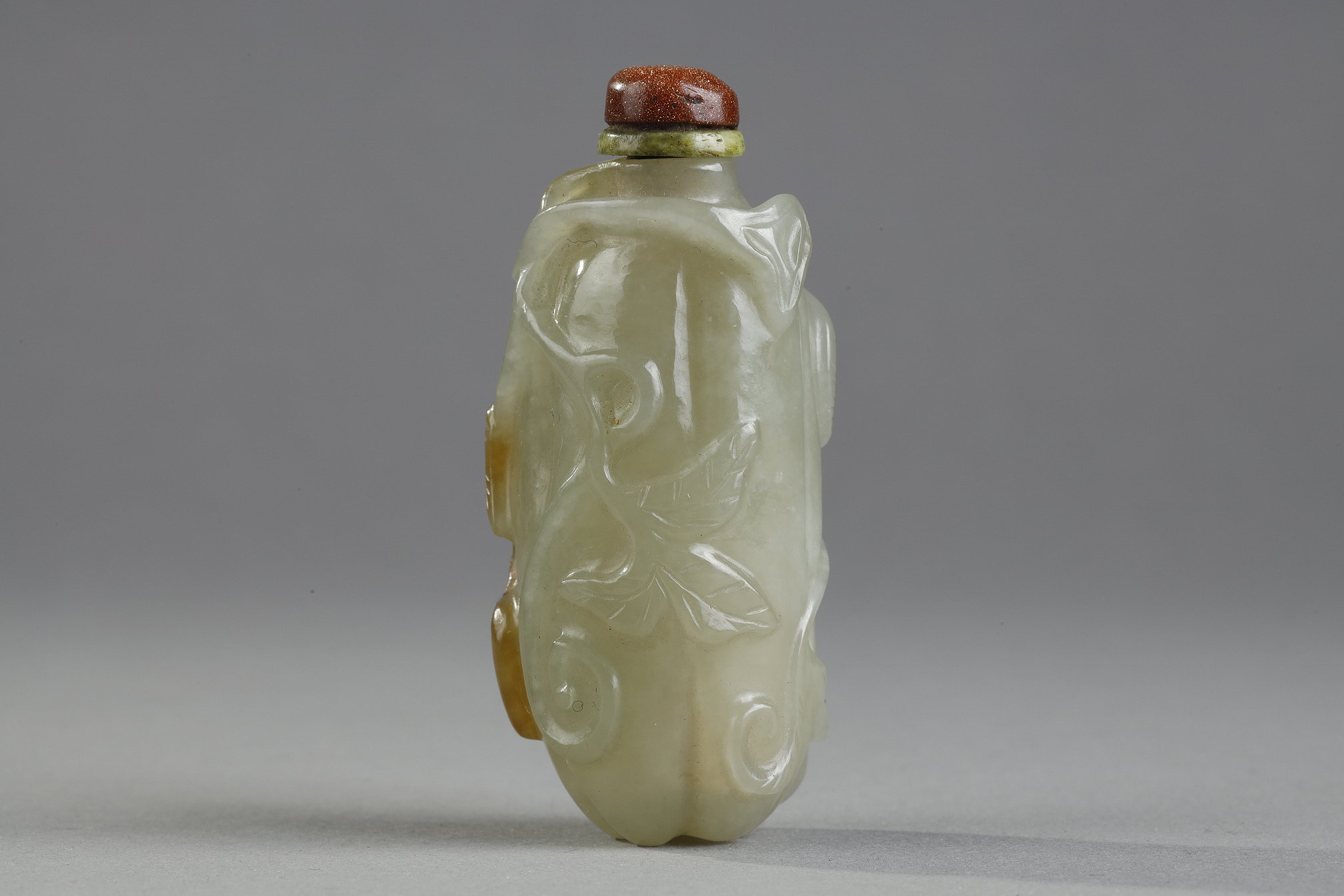 Snuff Bottles : Celadon green nephrite jade snuffbottle in the shape of .pumpkin with its leaves and another small fruit in a reddish brown inclusion - China 19th century