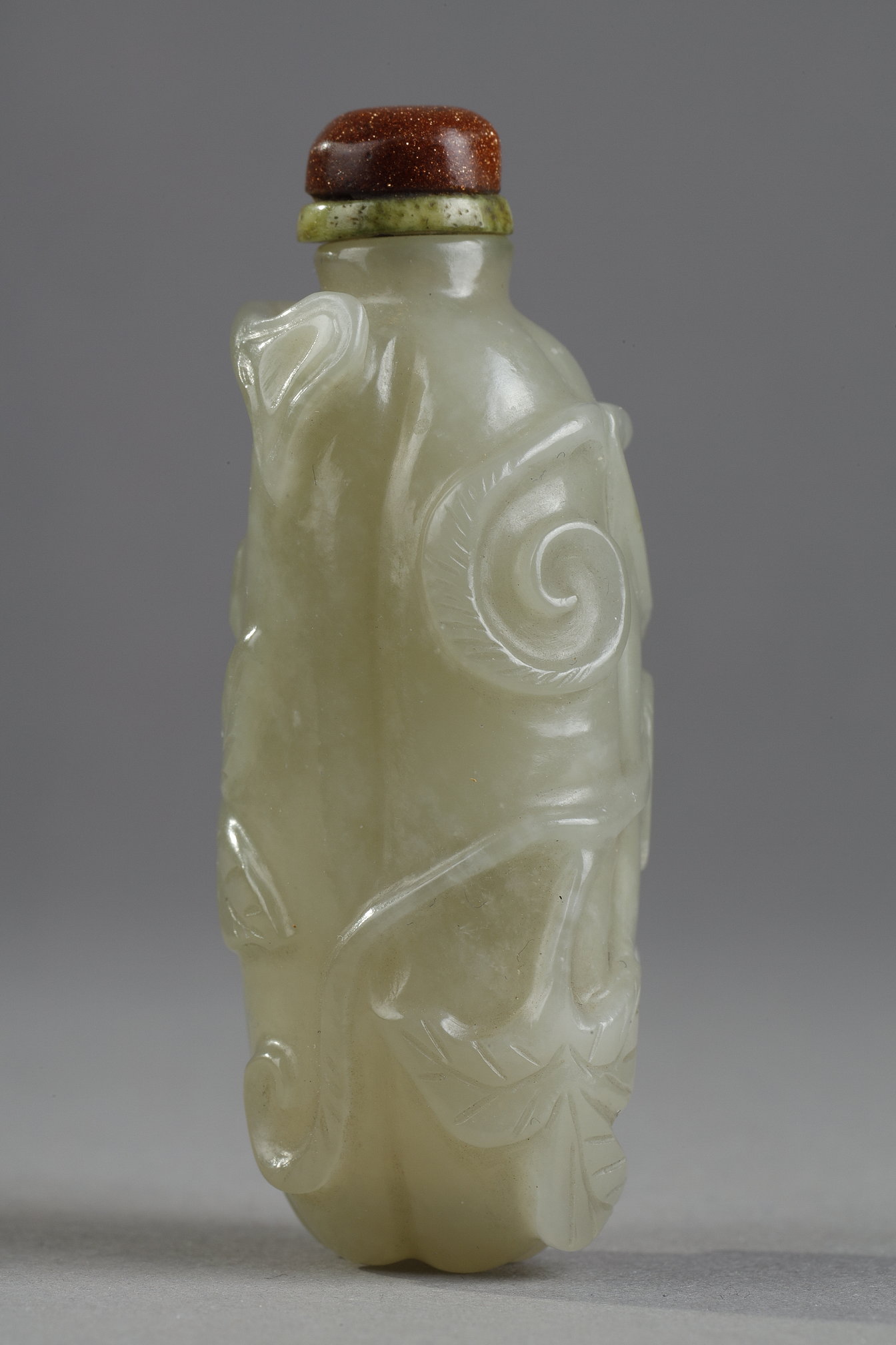 Snuff Bottles : Celadon green nephrite jade snuffbottle in the shape of .pumpkin with its leaves and another small fruit in a reddish brown inclusion - China 19th century