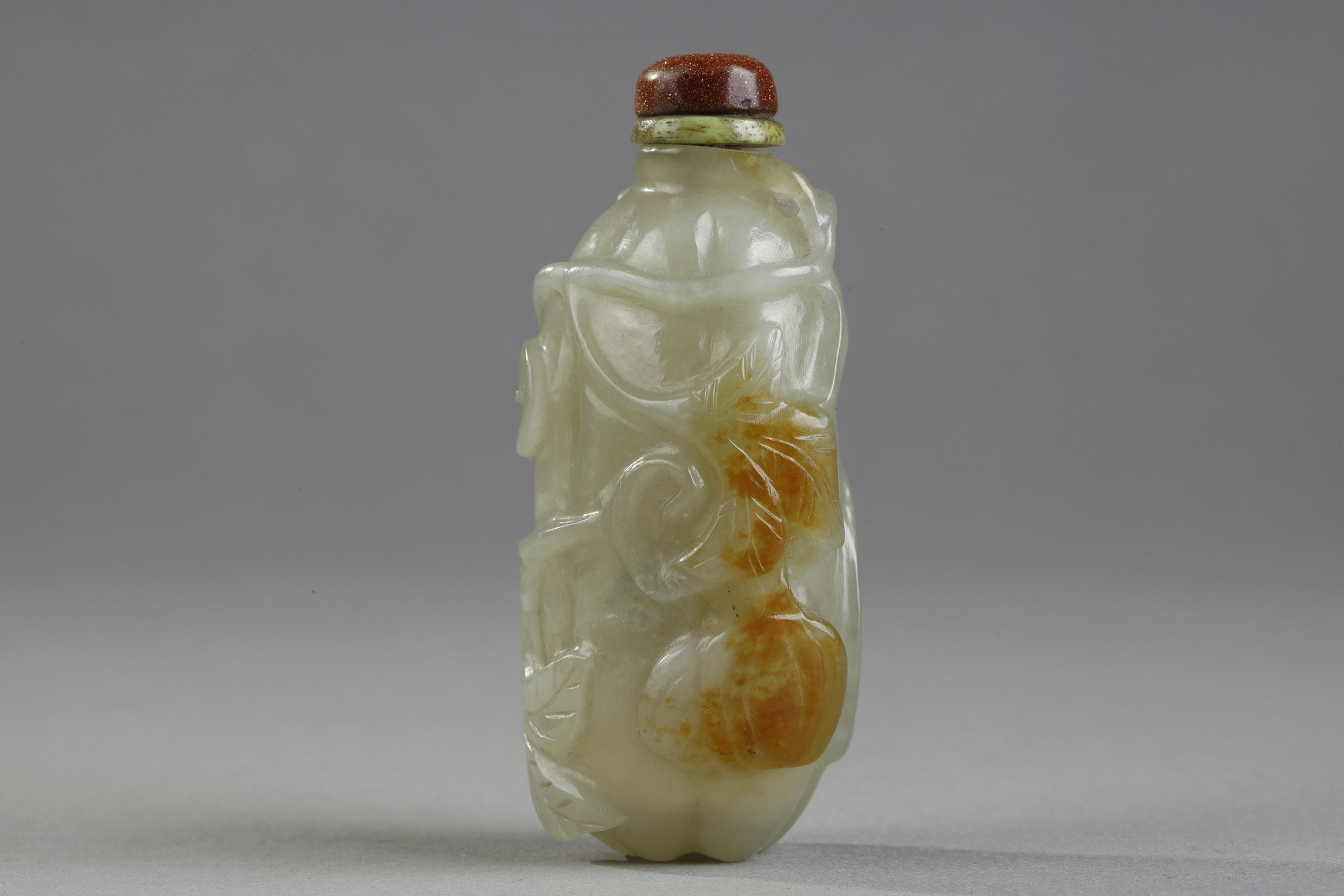 Snuff Bottles : Celadon green nephrite jade snuffbottle in the shape of .pumpkin with its leaves and another small fruit in a reddish brown inclusion - China 19th century