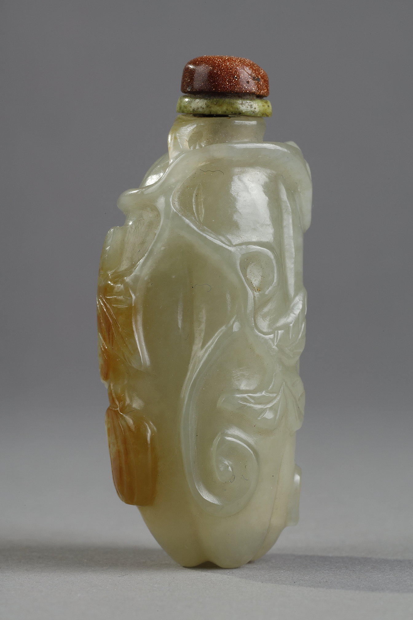 Snuff Bottles : Celadon green nephrite jade snuffbottle in the shape of .pumpkin with its leaves and another small fruit in a reddish brown inclusion - China 19th century