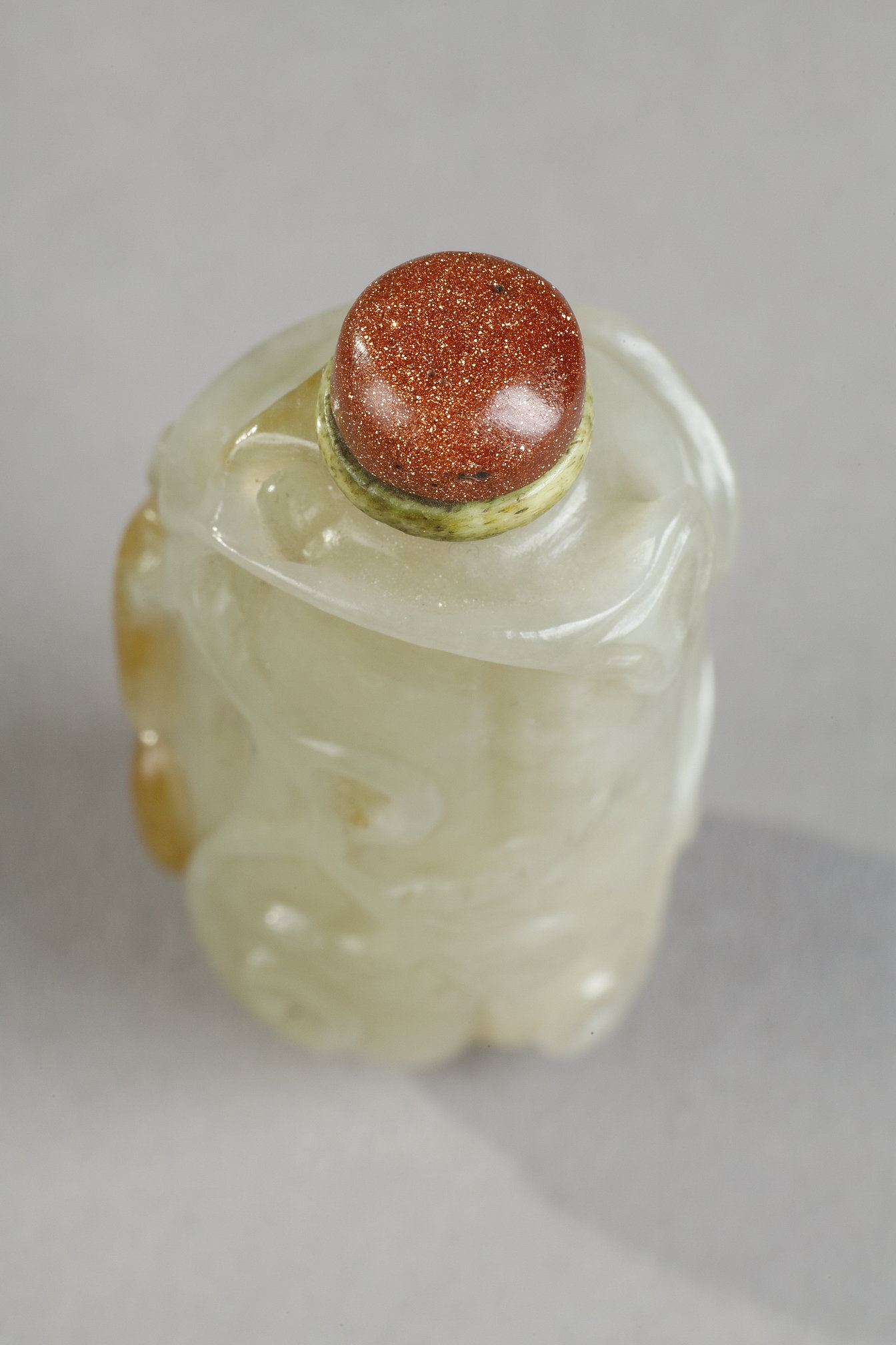 Snuff Bottles : Celadon green nephrite jade snuffbottle in the shape of .pumpkin with its leaves and another small fruit in a reddish brown inclusion - China 19th century