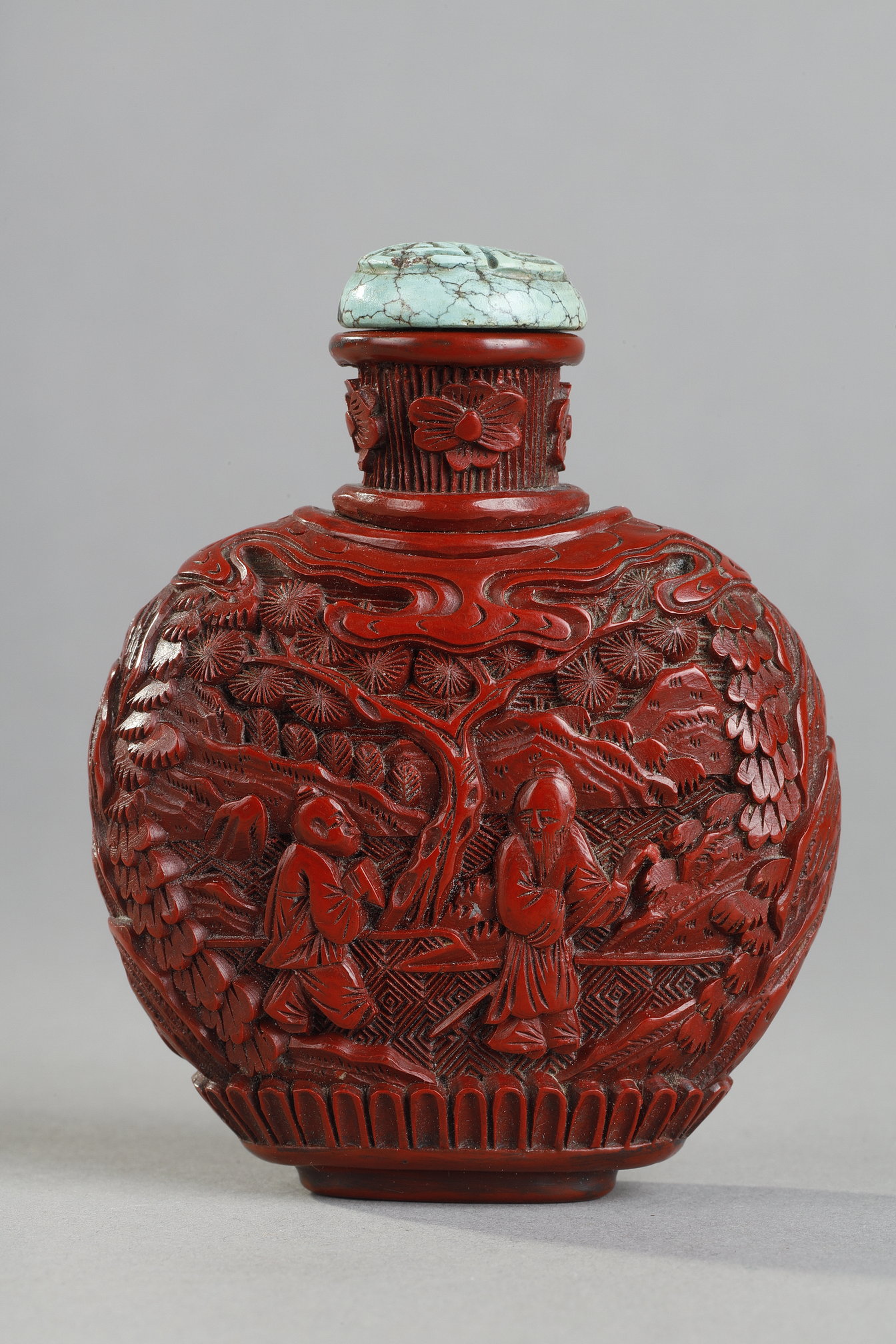Snuff Bottles : Cinnabar red lacquer snuffbottle decorated with scholars under the pines . the sides decorated with rocks - China 19th century